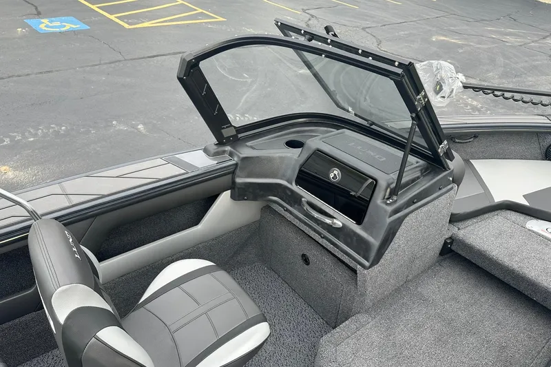 Slide: The Image of 2026 Lund 1775 Crossover XS boat interior with open windshield and seating. - 23