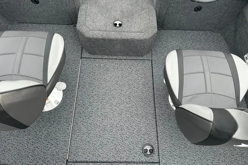 Slide: The Image of 2026 Lund 1775 Crossover XS boat interior with two gray seats and carpeted floor. - 24