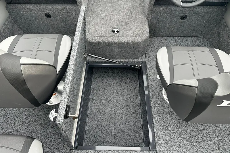Slide: The Image of 2026 Lund 1775 Crossover XS boat interior with open storage compartment and two seats. - 25