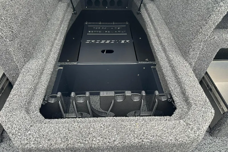 Slide: The Image of 2026 Lund 1775 Crossover XS boat storage compartment with organized interior layout. - 26