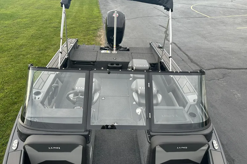 Slide: The Image of 2026 Lund 1775 Crossover XS boat, interior view, featuring seating and steering wheel. - 27