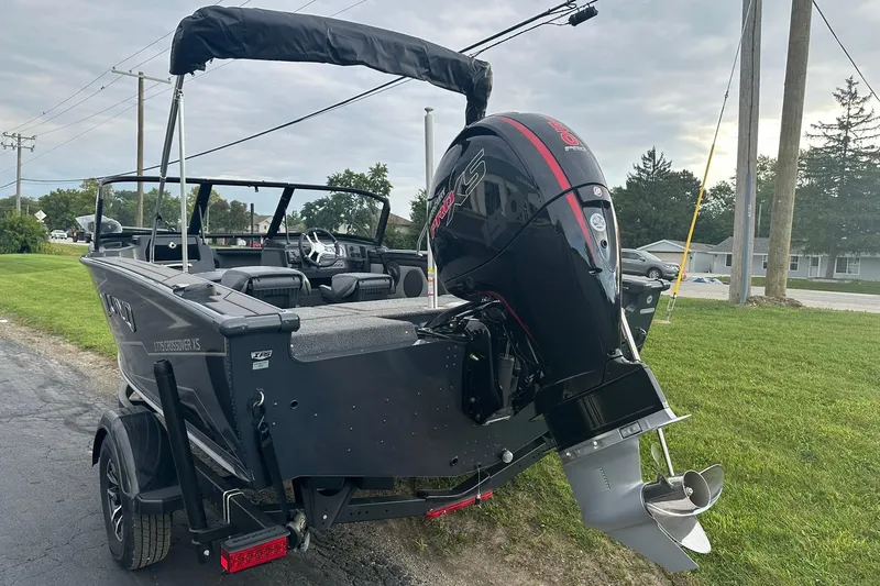 Slide: The Image of 2026 Lund 1775 Crossover XS boat with powerful outboard motor on a trailer. - 3