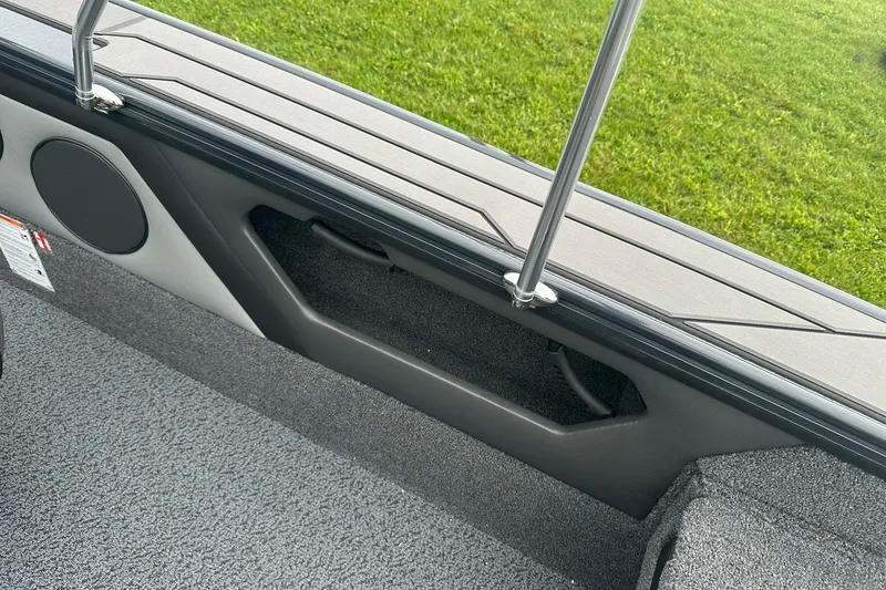 Slide: The Image of 2026 Lund 1775 Crossover XS interior detail with speaker and storage compartment. - 31