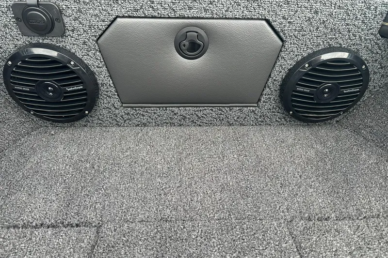 Slide: The Image of 2026 Lund 1775 Crossover XS interior with marine-grade speakers and carpeted finish. - 32