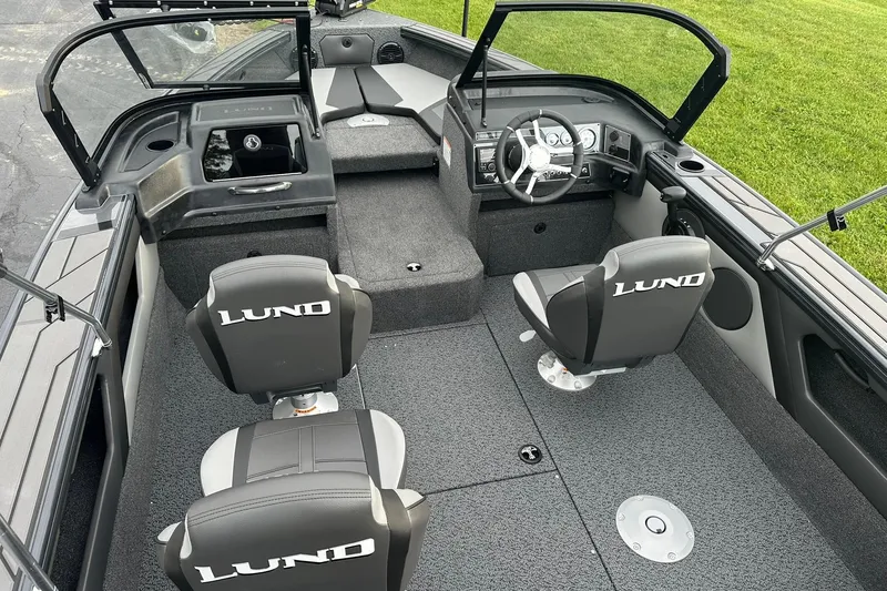 Slide: The Image of 2026 Lund 1775 Crossover XS boat interior with seating and steering wheel. - 7