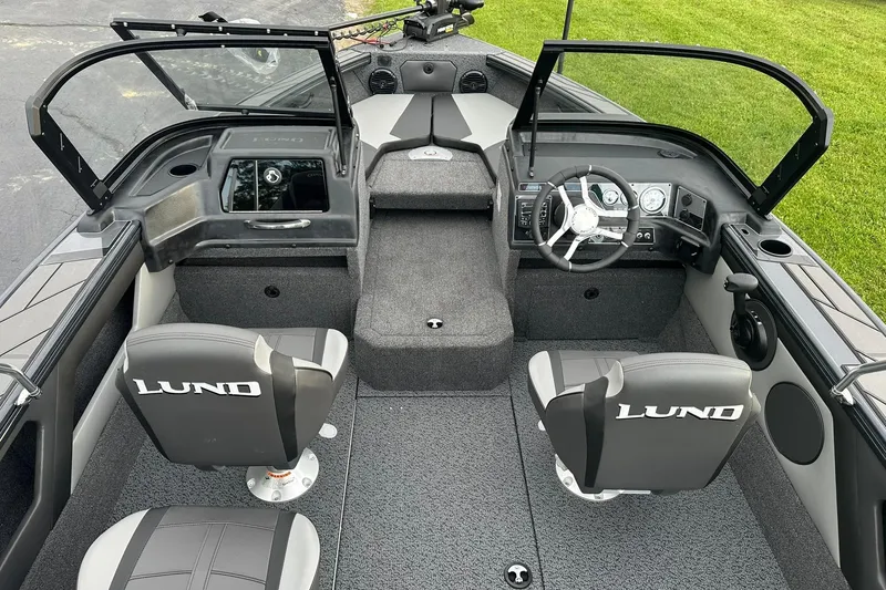 Slide: The Image of 2026 Lund 1775 Crossover XS boat interior with steering wheel and seating. - 8