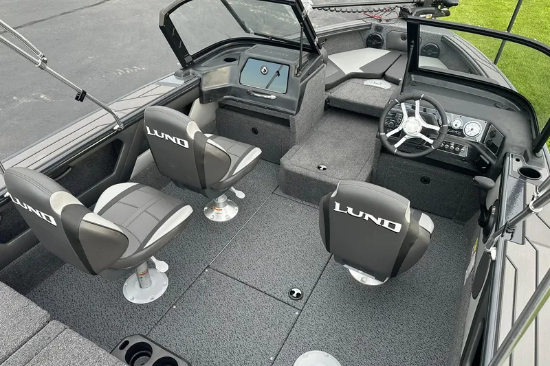 Slide: The Image of 2026 Lund 1775 Crossover XS boat interior with seating and steering console. - 9