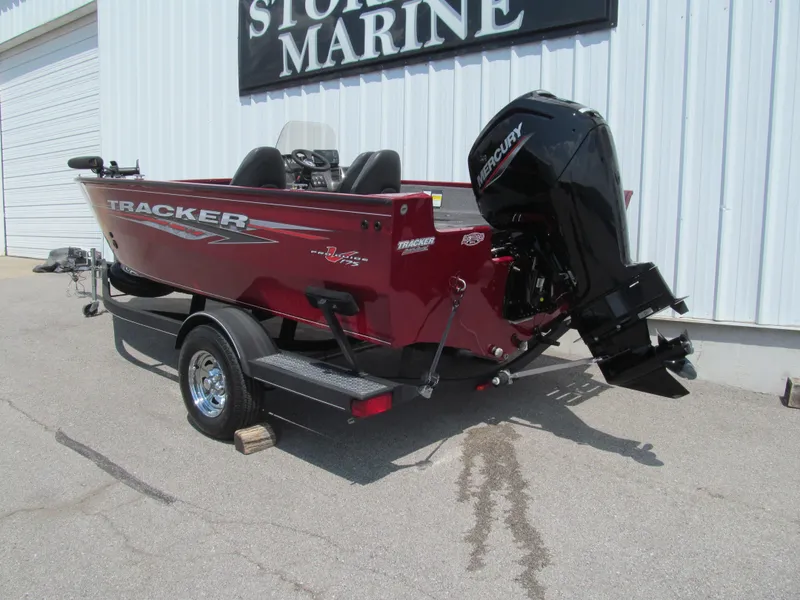 Slide: The Image of 2020 Tracker Pro Guide V-175 SC boat with Mercury outboard motor, parked outside a marine store. - 3