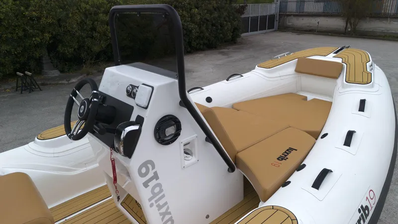 Slide: The Image of 2025 Aqvaboats luxrib 19 inflatable boat with tan seating and modern console. - 10