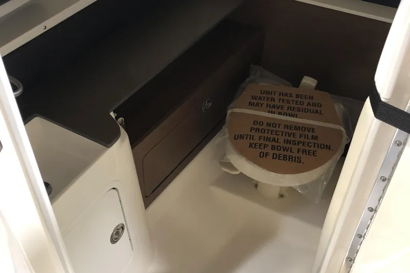 Slide: The Image of 2025 Sea Ray SDX 290 interior with protective film on toilet, showcasing sleek design. - 12