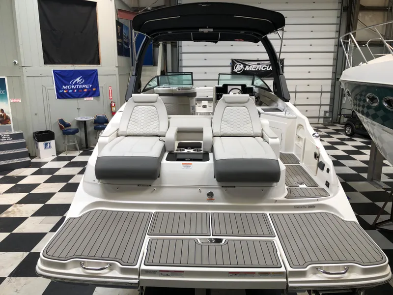 Slide: The Image of 2025 Sea Ray SDX 290 boat in showroom, featuring sleek seating and modern design. - 2