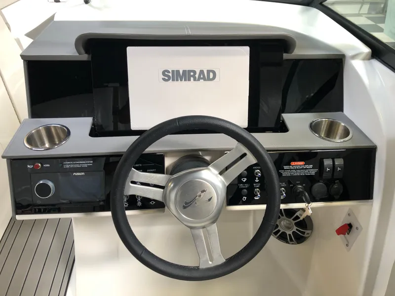 Slide: The Image of 2025 Sea Ray SDX 290 helm with Simrad display and steering wheel. - 9