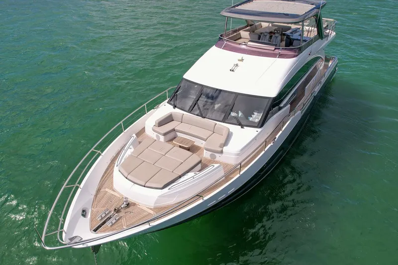 Slide: The Image of Luxury 2021 Princess Y78 yacht cruising on clear green waters. - 7