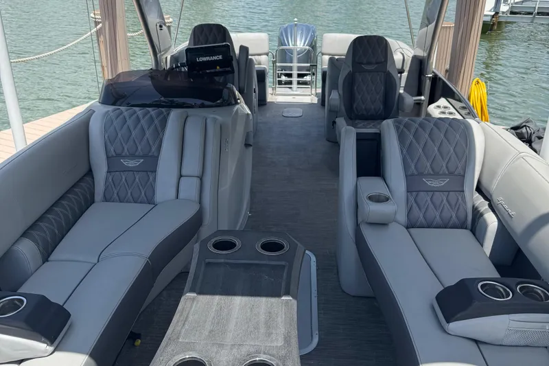 Slide: The Image of 2022 Bennington RX 25 RXFBA luxury boat interior with plush seating and cup holders. - 10