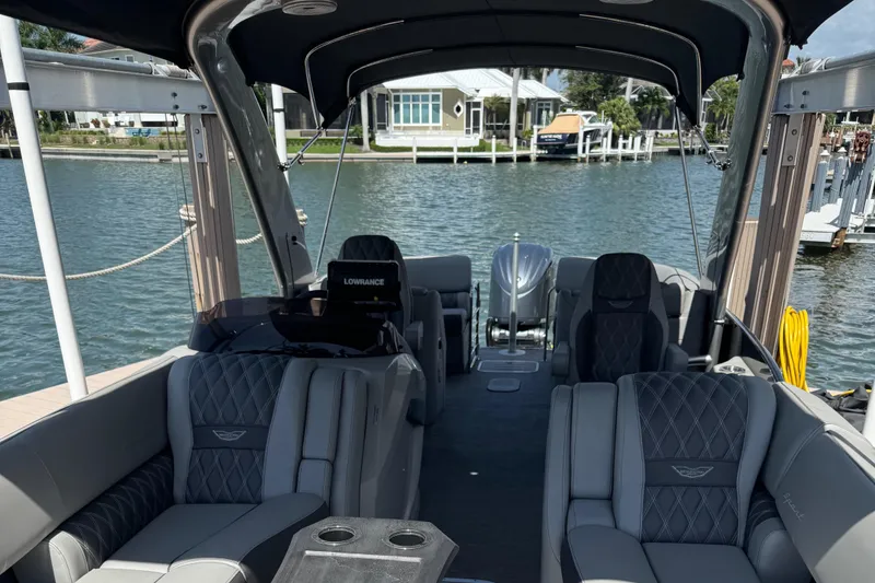 Slide: The Image of Luxurious 2022 Bennington RX 25 RXFBA pontoon boat interior with plush seating and water view. - 12