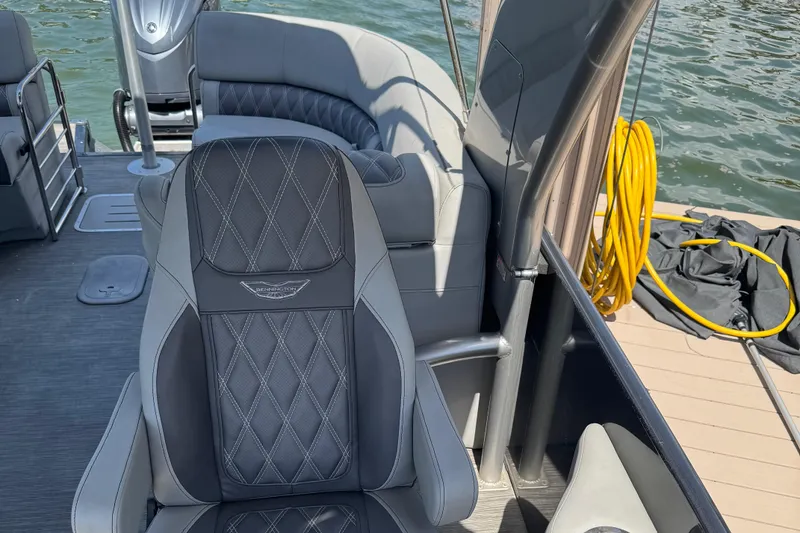 Slide: The Image of 2022 Bennington RX 25 RXFBA boat interior with luxurious seating and water view. - 13