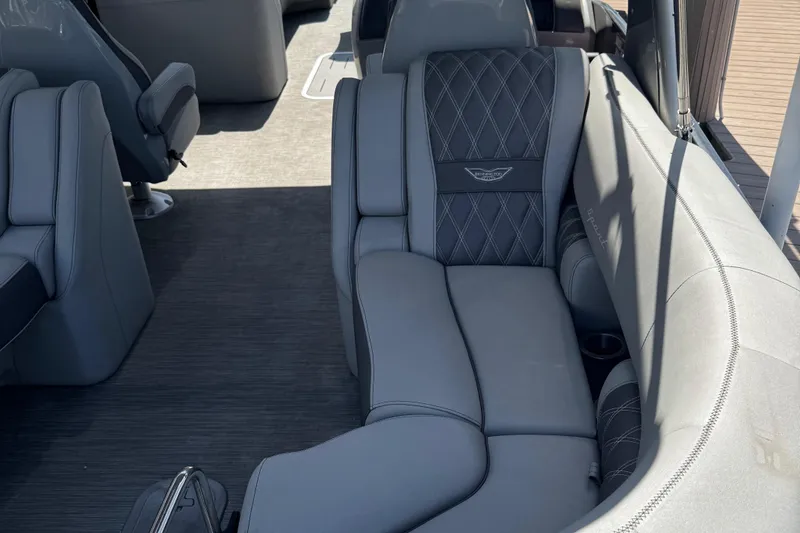Slide: The Image of Luxurious seating on 2022 Bennington RX 25 RXFBA boat, featuring elegant gray upholstery. - 16