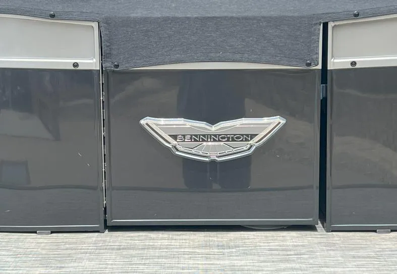 Slide: The Image of 2022 Bennington RX 25 RXFBA boat with logo on dark panel. - 7