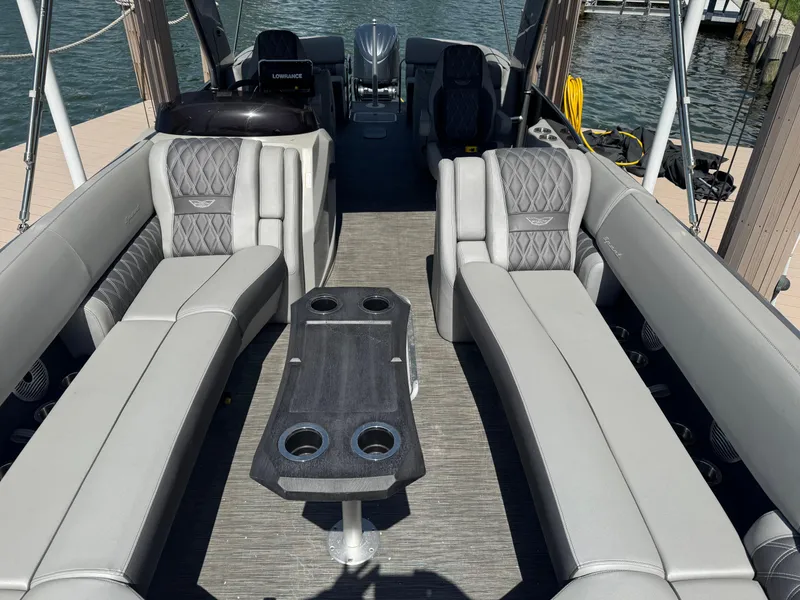Slide: The Image of 2022 Bennington RX 25 RXFBA pontoon boat interior with luxurious seating and table. - 8