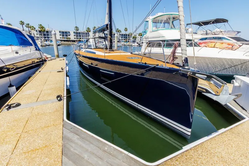 The Image of 2017 Solaris 50 yacht docked at marina, surrounded by other boats, under clear blue sky. - 0