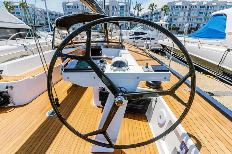 Slide: The Image of Steering wheel of a 2017 Solaris 50 yacht, docked in a marina. - 16