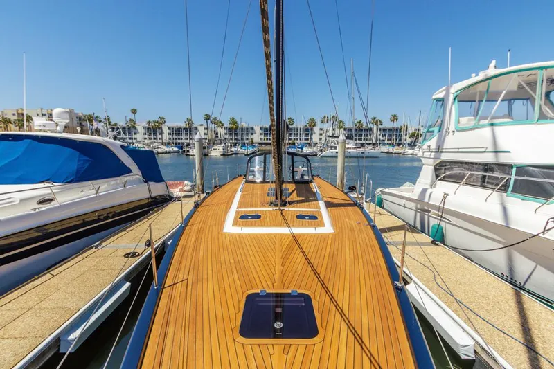 Slide: The Image of 2017 Solaris 50 yacht docked at marina, surrounded by other boats under clear blue sky. - 2
