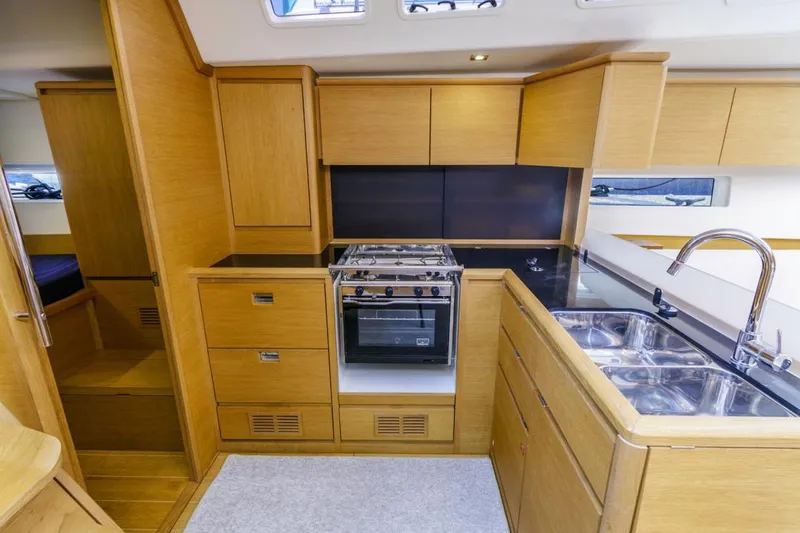 Slide: The Image of Modern kitchen interior of 2017 Solaris 50 yacht with wood cabinetry and stainless steel sink. - 27