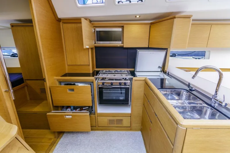 Slide: The Image of Modern kitchen interior of 2017 Solaris 50 yacht with wooden cabinets and stainless steel appliances. - 28