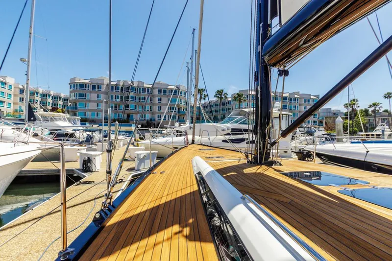 Slide: The Image of Luxurious 2017 Solaris 50 yacht docked in a marina with modern buildings in the background. - 3