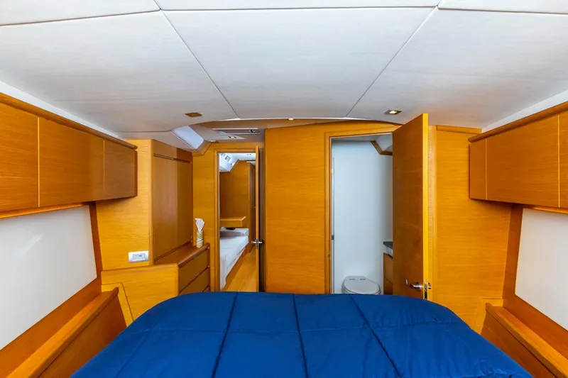 Slide: The Image of Luxurious interior of 2017 Solaris 50 yacht with wooden finish and blue bedding. - 34