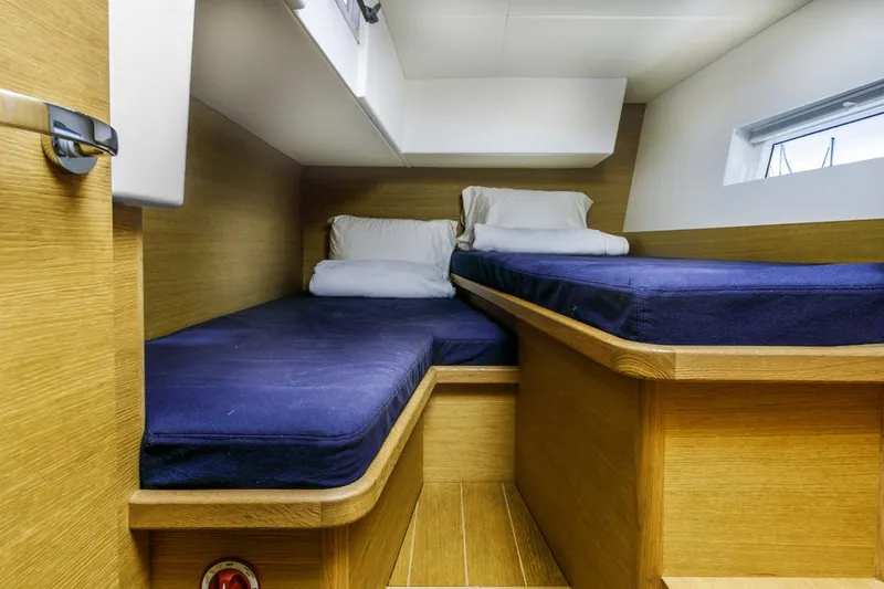 Slide: The Image of Cozy twin cabin in 2017 Solaris 50 yacht with blue bedding and wooden interior. - 36