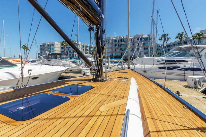 Slide: The Image of Luxurious 2017 Solaris 50 yacht docked at marina, showcasing sleek wooden deck design. - 4