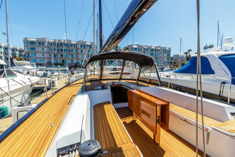 Slide: The Image of Luxurious 2017 Solaris 50 yacht with teak deck, docked in a marina under clear blue skies. - 8