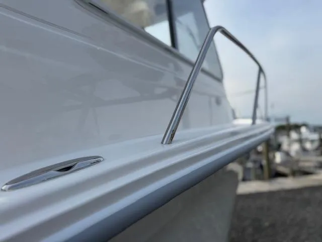 Slide: The Image of Close-up of 2025 NorthCoast 235 HT boat railing and hull detail. - 11