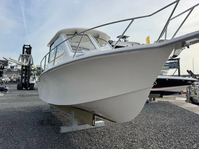 Slide: The Image of 2025 NorthCoast 235 HT boat displayed on gravel lot, side view. - 12