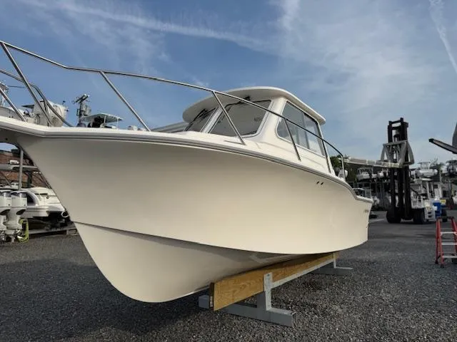 Slide: The Image of 2025 NorthCoast 235 HT boat on display in a marina setting. - 2