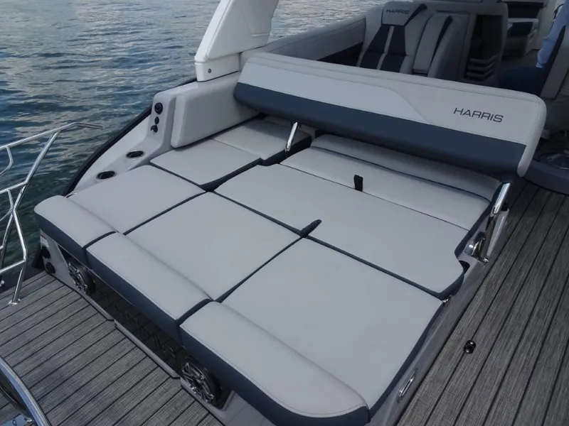 Slide: The Image of 2025 Harris Grand Mariner 250 boat with spacious, luxurious seating on a wooden deck. - 11