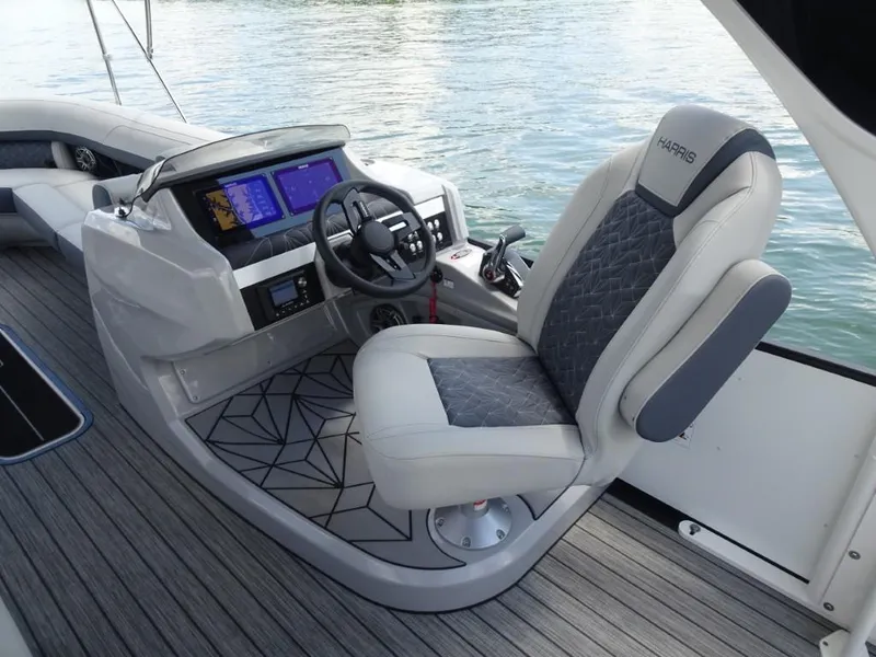 Slide: The Image of 2025 Harris Grand Mariner 250 helm with modern controls and luxurious seating. - 14