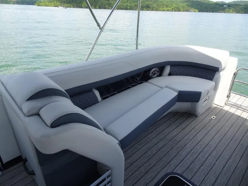 Slide: The Image of Luxurious seating on 2025 Harris Grand Mariner 250 boat, overlooking serene lake waters. - 19