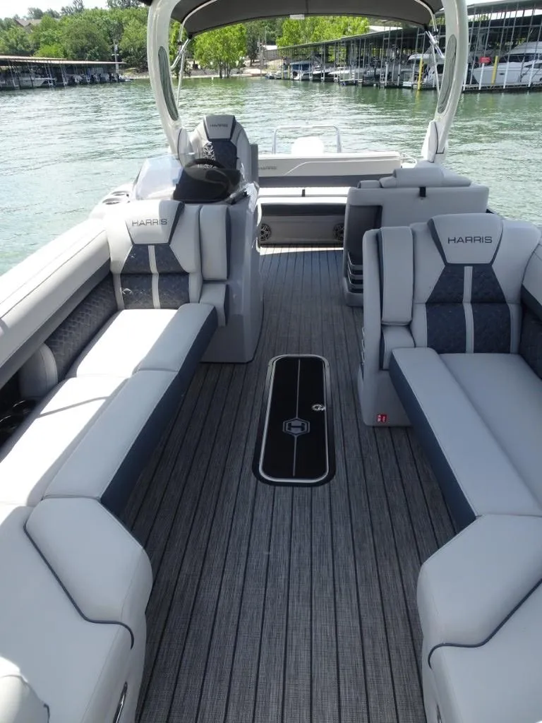 Slide: The Image of 2025 Harris Grand Mariner 250 pontoon boat interior with luxurious seating and sleek design. - 20