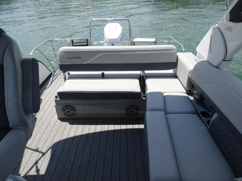Slide: The Image of 2025 Harris Grand Mariner 250 boat interior with gray seating and wooden deck. - 24