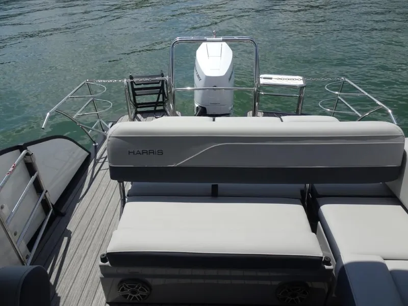 Slide: The Image of 2025 Harris Grand Mariner 250 pontoon boat with spacious seating and modern design on water. - 25