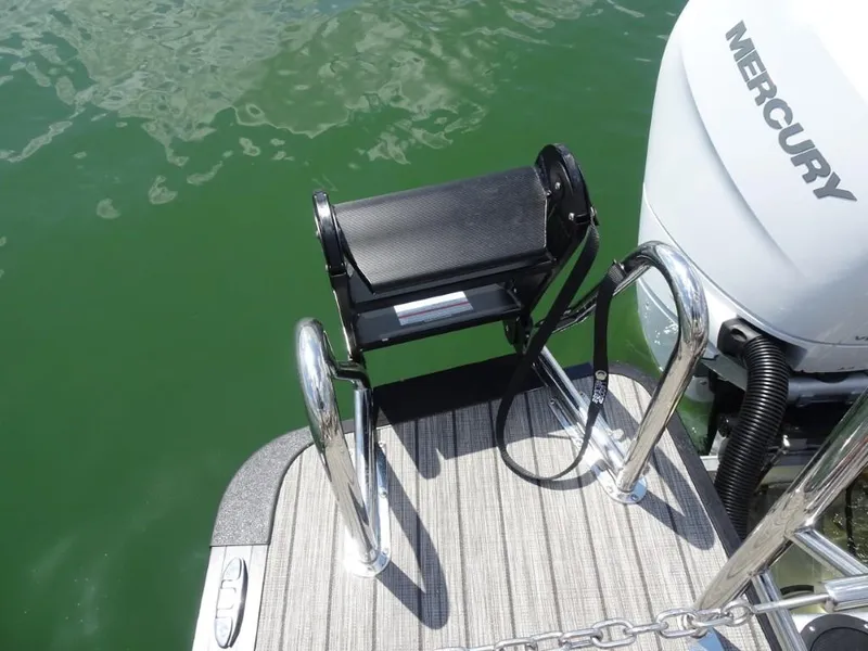Slide: The Image of 2025 Harris Grand Mariner 250 boat with Mercury engine and swim platform ladder. - 27