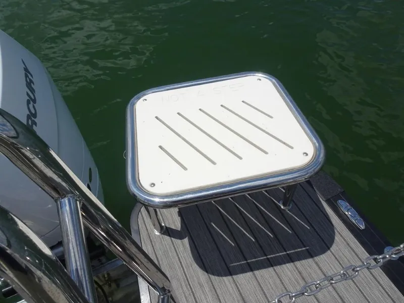 Slide: The Image of 2025 Harris Grand Mariner 250 boat platform with "Not a Step" warning near water. - 28