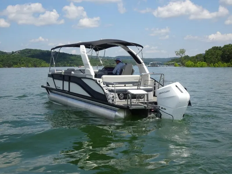 Slide: The Image of 2025 Harris Grand Mariner 250 pontoon boat cruising on a scenic lake. - 4