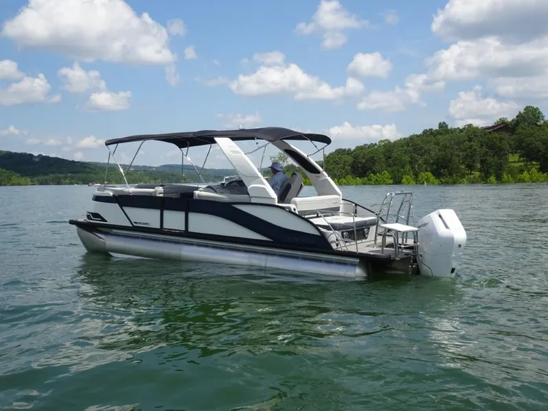 Slide: The Image of 2025 Harris Grand Mariner 250 pontoon boat on a scenic lake under a cloudy sky. - 5