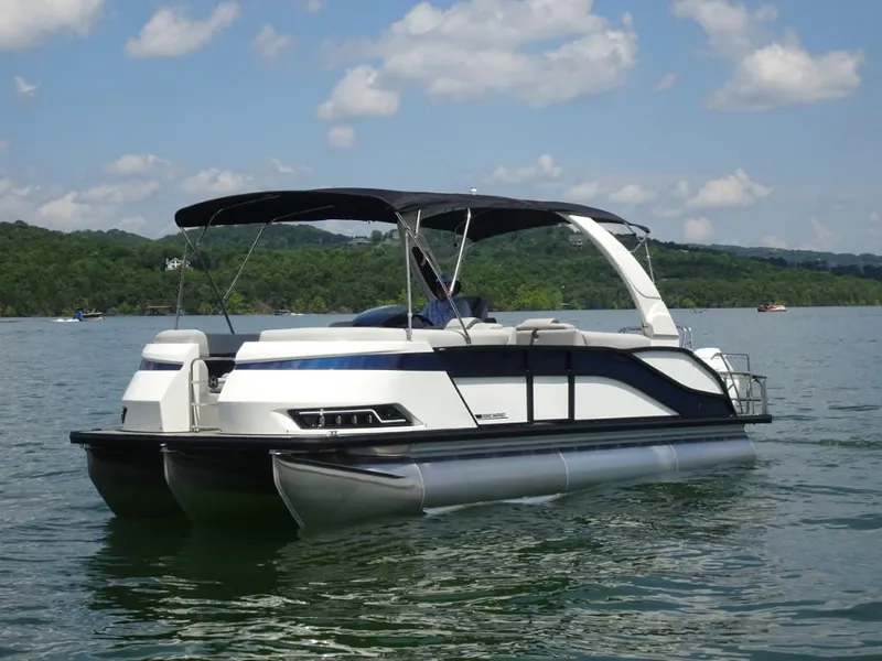 Slide: The Image of 2025 Harris Grand Mariner 250 pontoon boat on a scenic lake. - 8