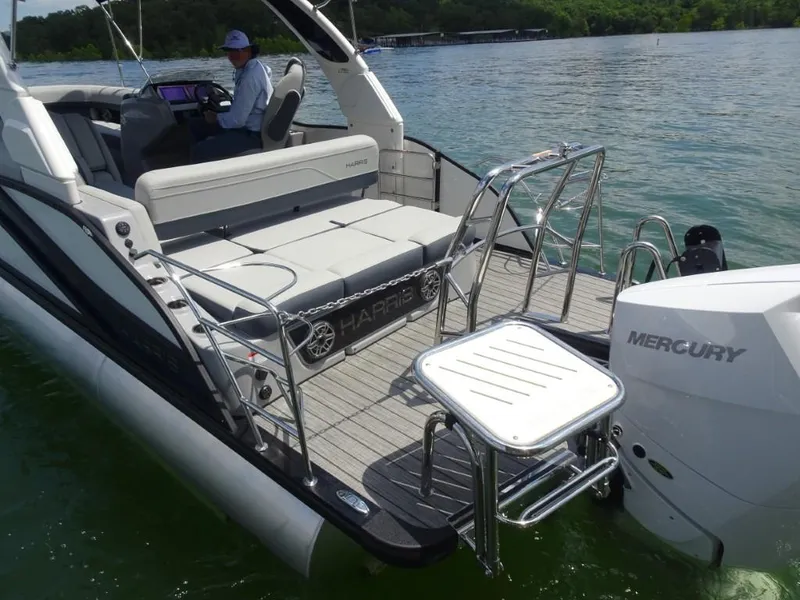 Slide: The Image of 2025 Harris Grand Mariner 250 boat with Mercury engine, featuring spacious seating and swim platform. - 9