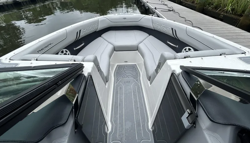 Slide: The Image of 2026 Regal LX2 boat interior with sleek gray seating and modern design. - 10