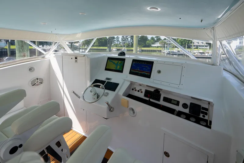 Slide: The Image of 2007 Custom Carolina Layton Express helm with modern navigation equipment and plush seating. - 12